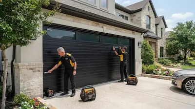 technicians installing new garage door on home in Garland TX
